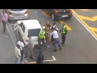 a police officer punches a naked man in the groin. mm